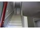 Entry stairwell leading to the upper level with neutral walls and white trim at 4314 Saddlecreek Ct, Auburn, GA 30011