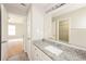 Bright bathroom featuring a granite countertop, white cabinetry, and a large mirror over the sink at 5228 Kirk Dr, Atlanta, GA 30349