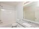 Bathroom with a granite countertop, white tub, and a large mirror at 5228 Kirk Dr, Atlanta, GA 30349