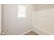 Bathroom featuring a white tub with shower and a bright window at 5228 Kirk Dr, Atlanta, GA 30349