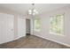 Sunny bedroom with wood-look floors, ample natural light, and closet space at 5228 Kirk Dr, Atlanta, GA 30349