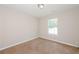 Bedroom with neutral carpet, a bright window, and white walls at 5228 Kirk Dr, Atlanta, GA 30349