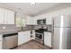 Well-equipped kitchen featuring stainless steel appliances, granite countertops, and white cabinets at 5228 Kirk Dr, Atlanta, GA 30349