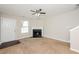 Inviting living room features a fireplace, ceiling fan, and neutral carpet at 5228 Kirk Dr, Atlanta, GA 30349