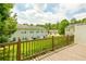 Wide view from a wooden deck highlighting green backyard and neighbor units on a sunny day at 809 Brickleridge Se Ln, Mableton, GA 30126