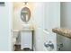 Clean half-bath with pedestal sink, oval mirror, and crisp white door and trim at 809 Brickleridge Se Ln, Mableton, GA 30126