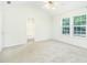 Airy bedroom with vaulted ceiling featuring large windows and a glimpse of the ensuite bath at 809 Brickleridge Se Ln, Mableton, GA 30126