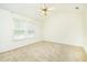 Carpeted bedroom with ceiling fan and bright natural light from two windows at 809 Brickleridge Se Ln, Mableton, GA 30126