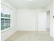 An empty bedroom with a large window and new carpet shows a neutral color scheme at 809 Brickleridge Se Ln, Mableton, GA 30126