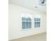 Sun-filled bedroom with neutral walls and carpet, plus a modern ceiling fan and updated window blinds at 809 Brickleridge Se Ln, Mableton, GA 30126