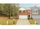 Charming brick townhome featuring an attached garage, driveway, and neatly maintained landscaping at 809 Brickleridge Se Ln, Mableton, GA 30126
