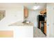 Well-maintained kitchen featuring stone countertops, black appliances, and wood cabinets at 809 Brickleridge Se Ln, Mableton, GA 30126