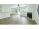 Spacious living area with fireplace, hardwood floors, natural light, and breakfast bar at 809 Brickleridge Se Ln, Mableton, GA 30126