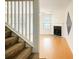 Welcoming living room featuring a cozy fireplace and staircase to the upper level at 809 Brickleridge Se Ln, Mableton, GA 30126