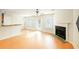 Open-concept living room with hardwood floors, fireplace, ceiling fan, and access to the backyard at 809 Brickleridge Se Ln, Mableton, GA 30126