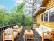 Relaxing back deck featuring an outdoor sofa, chairs, and views of the surrounding trees at 2129 Fairhaven Ne Cir, Atlanta, GA 30305