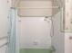 Bathroom with tiled walls and a green-colored bathtub and shower area at 2129 Fairhaven Ne Cir, Atlanta, GA 30305