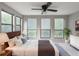 Bedroom featuring hard wood bed frame, ceiling fan, three windows, and plant at 2129 Fairhaven Ne Cir, Atlanta, GA 30305