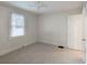Empty neutral carpeted bedroom with one window and a ceiling fan at 2129 Fairhaven Ne Cir, Atlanta, GA 30305