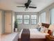 Bedroom featuring hard wood bed frame, ceiling fan, and three windows at 2129 Fairhaven Ne Cir, Atlanta, GA 30305