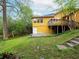 Exterior shot of the house from the backyard featuring an elevated deck and a sunny, painted exterior at 2129 Fairhaven Ne Cir, Atlanta, GA 30305