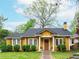 Charming yellow bungalow-style home with a well-maintained front yard and inviting brick pathway at 2129 Fairhaven Ne Cir, Atlanta, GA 30305