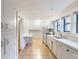 Spacious kitchen with white cabinets, tile floors, and plenty of natural light from three windows at 2129 Fairhaven Ne Cir, Atlanta, GA 30305