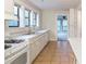 Traditional kitchen with white cabinets, tile floors, and three windows providing natural light at 2129 Fairhaven Ne Cir, Atlanta, GA 30305