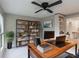 Office with built-in shelving, large windows, fan, and wood desk at 2129 Fairhaven Ne Cir, Atlanta, GA 30305