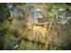 View of the back of a home with a backyard space mostly hidden by trees at 2275 Barrett Dr, Cumming, GA 30040