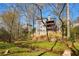 The back of a home overlooks a creek and an expansive, lush green space at 2275 Barrett Dr, Cumming, GA 30040