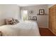 Cozy bedroom with a comfortable bed, natural light, and wood closet doors at 2275 Barrett Dr, Cumming, GA 30040
