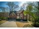 Beautiful brick home with manicured lawn, two-car garage, and mature trees at 2275 Barrett Dr, Cumming, GA 30040