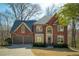 Charming two-story brick home with a well-manicured lawn and a two-car garage at 2275 Barrett Dr, Cumming, GA 30040