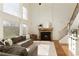 Spacious living room features a stone fireplace, large windows, and a comfortable sectional at 2275 Barrett Dr, Cumming, GA 30040