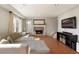Spacious living room featuring a stone fireplace, large window, and mounted television at 2275 Barrett Dr, Cumming, GA 30040