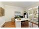 Well-lit home office with hardwood floors and a large window overlooking the yard at 2275 Barrett Dr, Cumming, GA 30040