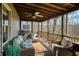 Spacious outdoor porch with ceiling fan and comfortable seating area with views of wooded area at 2275 Barrett Dr, Cumming, GA 30040