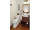 Nicely appointed powder room with hardwood floors, updated fixtures, and vessel sink at 2275 Barrett Dr, Cumming, GA 30040