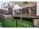 View of backyard patio with outdoor furniture, grill, and low maintenance artificial turf at 306 Atley Pl, Alpharetta, GA 30009