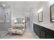 Bright bathroom with dual sinks, vanity, glass shower, and floral-patterned bench at 306 Atley Pl, Alpharetta, GA 30009
