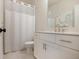 Bright bathroom with white vanity, toilet, and shower featuring an elephant artwork above the sink at 306 Atley Pl, Alpharetta, GA 30009