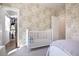 Charming bedroom showcasing wallpaper, closet, and crib at 306 Atley Pl, Alpharetta, GA 30009