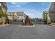 View of the community entrance gate with brick pillars, iron gates, and manicured landscaping in a gated community at 306 Atley Pl, Alpharetta, GA 30009