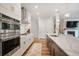Modern kitchen with stainless steel appliances, white cabinets, and a large island with a marble countertop at 306 Atley Pl, Alpharetta, GA 30009