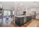 Open concept kitchen and living room featuring an island, stainless appliances, and hardwood floors at 306 Atley Pl, Alpharetta, GA 30009