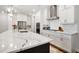 Modern kitchen with white cabinetry, stainless steel appliances, an island, and tile backsplash at 306 Atley Pl, Alpharetta, GA 30009