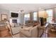Bright living room with a fireplace, ceiling fan, hardwood floors, and sliding doors to a patio at 306 Atley Pl, Alpharetta, GA 30009