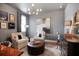 Cozy living room features neutral paint, accent lighting, and plush seating centered around a decorative rug at 306 Atley Pl, Alpharetta, GA 30009