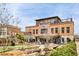 Exterior view of a multi-story brick building housing Jekyll Brewing and Central City Tavern with a patio and landscaping at 306 Atley Pl, Alpharetta, GA 30009